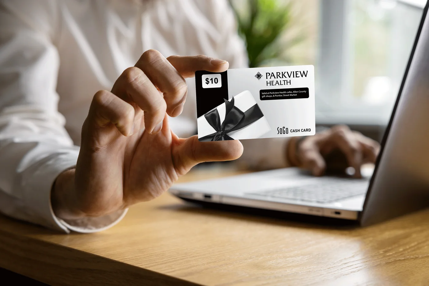 Parkview Health gift card held near a laptop